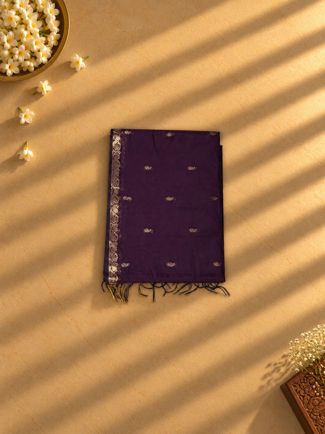 Deep purple Coimbatore cotton saree with gold paisley buttas, folded