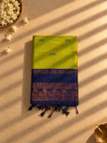 Lime green Gadwal cotton saree with navy peacock border, folded