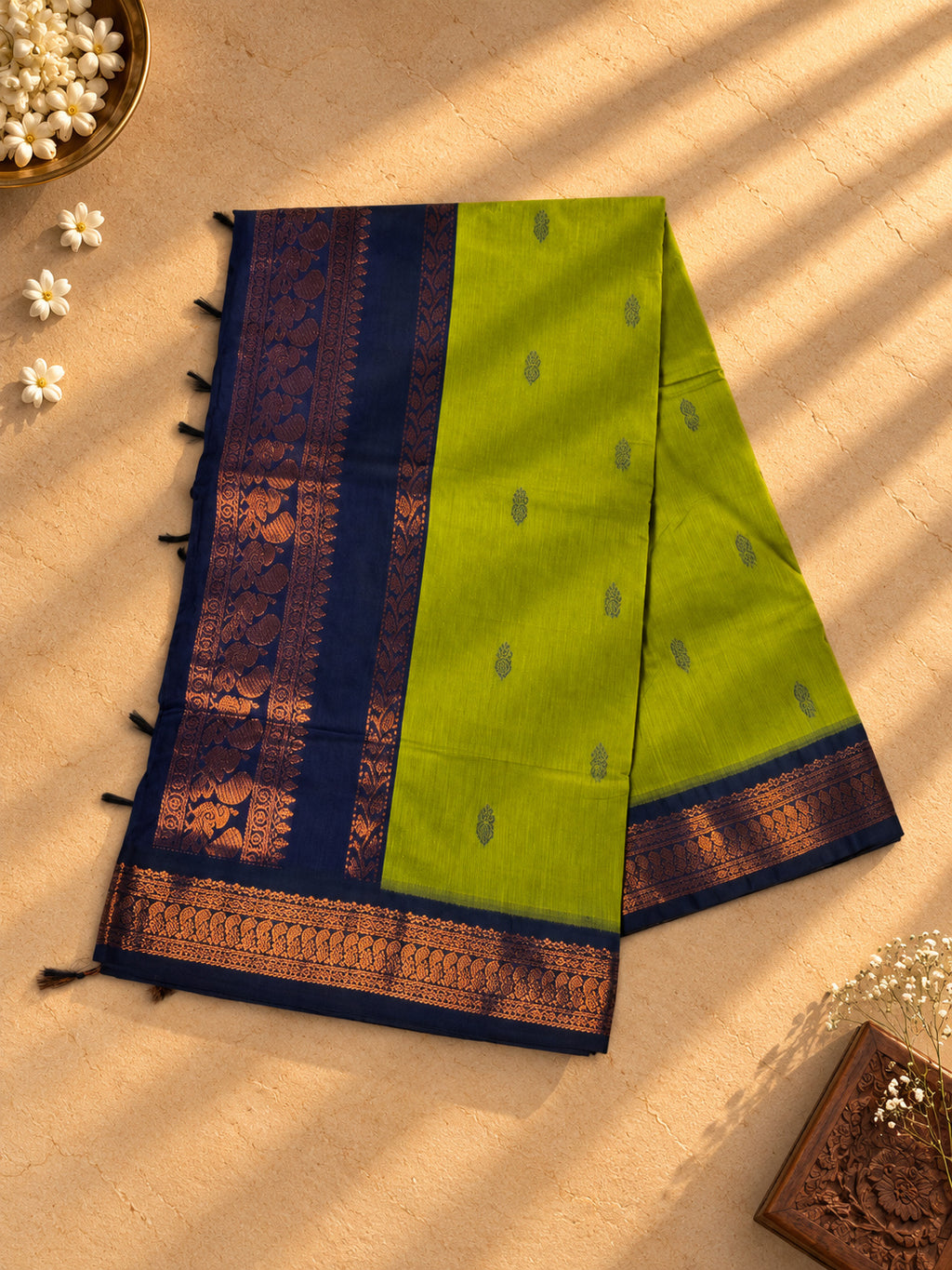 Lime green Gadwal cotton saree, navy pallu with copper zari peacocks