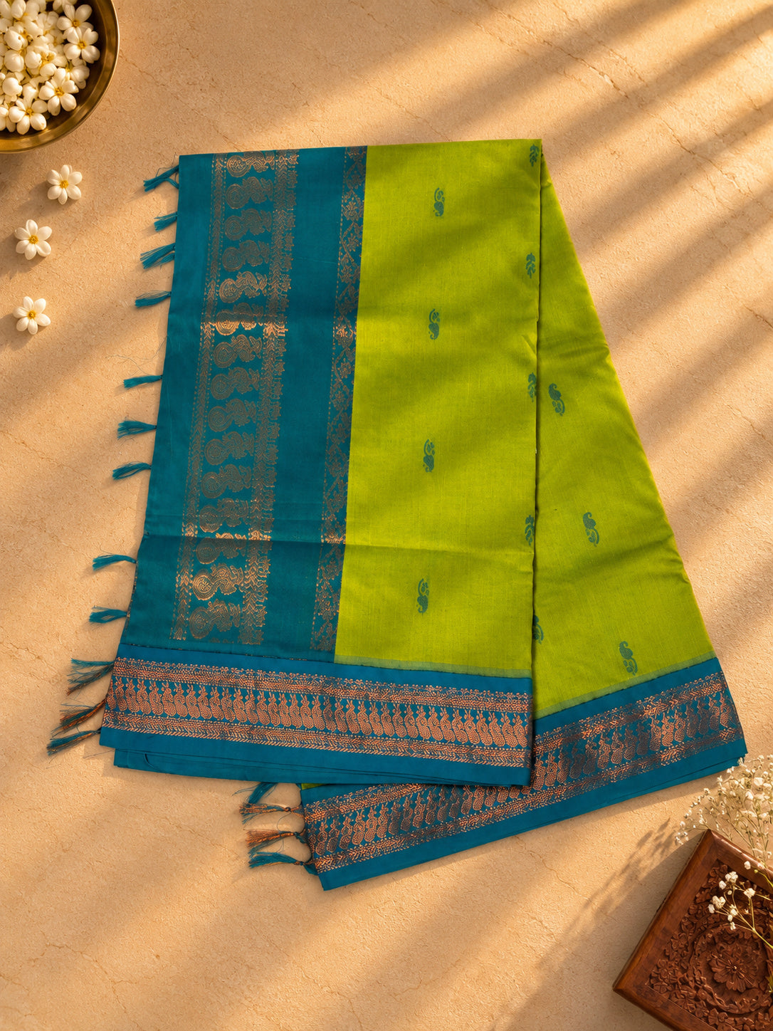 Lime green Gadwal cotton saree, teal pallu with copper zari peacocks