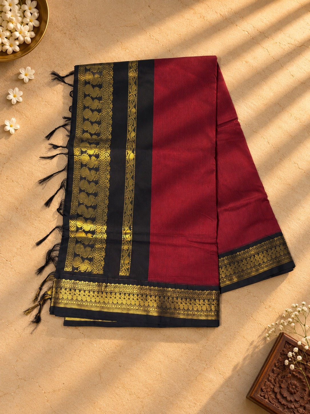 Maroon Gadwal cotton saree, black pallu with gold zari peacocks