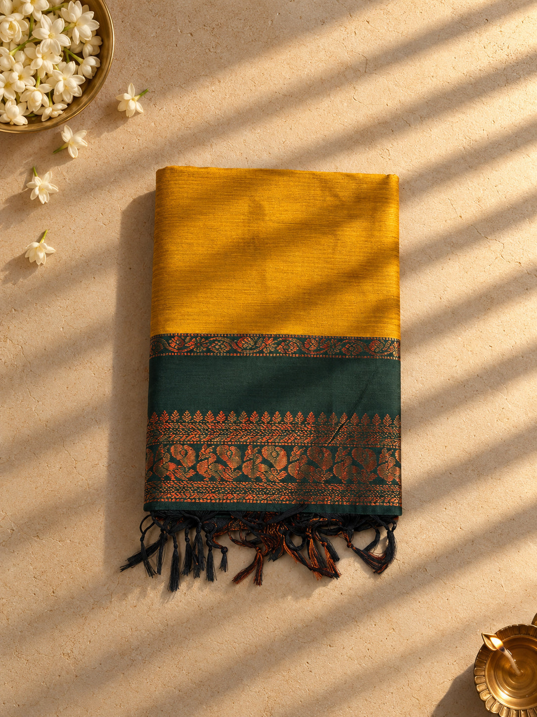 Mustard Gadwal cotton saree with bottle green peacock border, folded