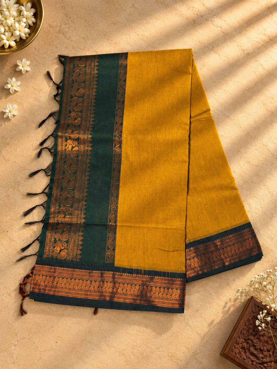 Mustard Gadwal cotton saree, bottle green pallu with copper zari peacocks