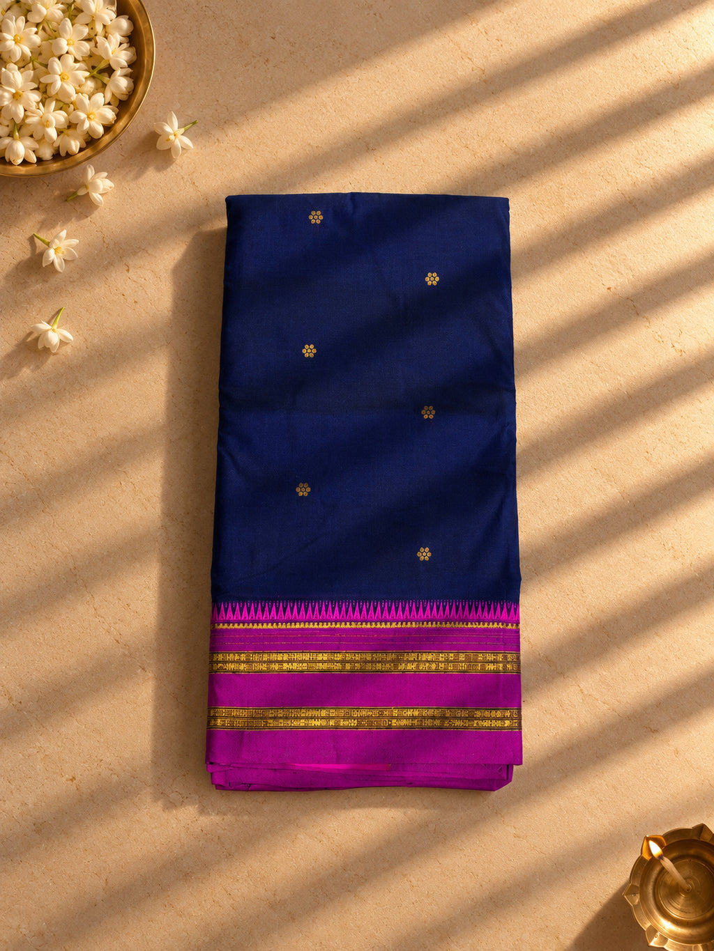 Navy blue Narayanpet cotton saree with magenta temple border, folded